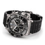 The Breitling Super Chronomat B01 44 is a stainless steel chronograph with a black bezel, three subdials, textured black rubber strap, tachymeter function, and is powered by the Breitling Manufacture 01 calibre movement.