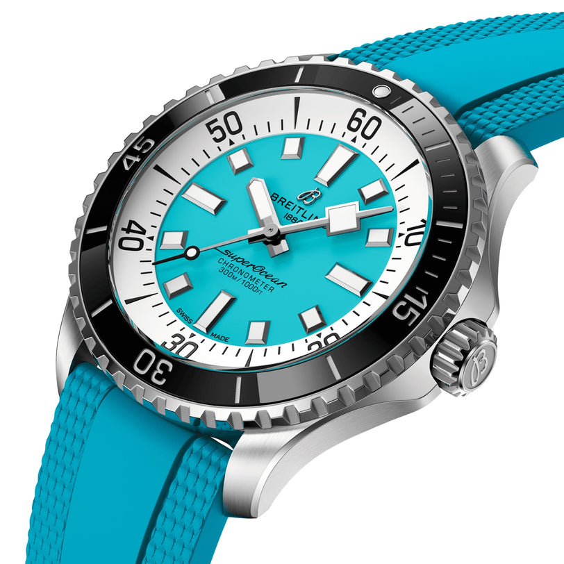 The Breitling Superocean Automatic 44 is a stainless steel watch with a turquoise dial, matching rubber strap, bold white hour markers, a black rotating bezel, and outstanding water resistance.