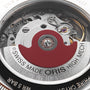 Close-up of the back of the Oris Big Crown Oris X Cervo Volante watch, showcasing its intricate movement, exposed gears, and signature red rotor marked SWISS MADE ORIS HIGH MECH.