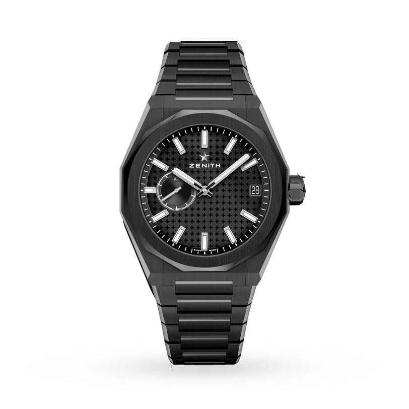 The Zenith Defy Skyline wristwatch features a black patterned dial, silver hour markers, date window at 3 o’clock, and a metal bracelet. It is displayed on a white background.