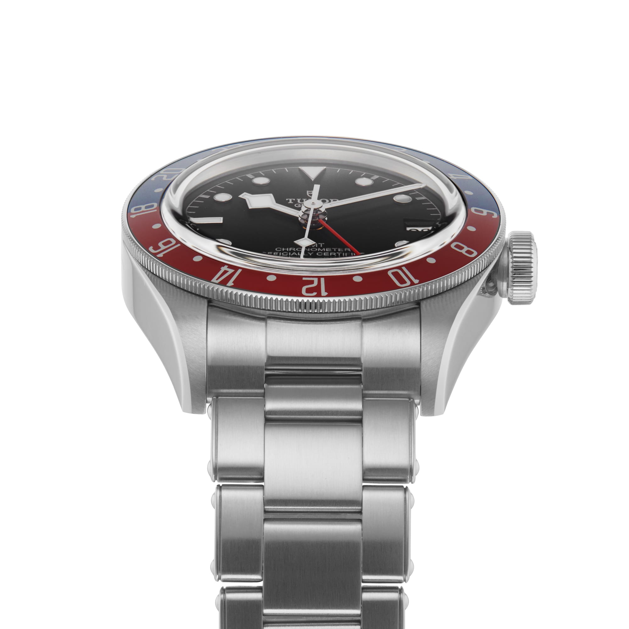 A TUDOR Black Bay GMT wristwatch in stainless steel with black dial, red and blue bezel, and metal bracelet, viewed from the front left—an iconic model inspired by classic diving watches.