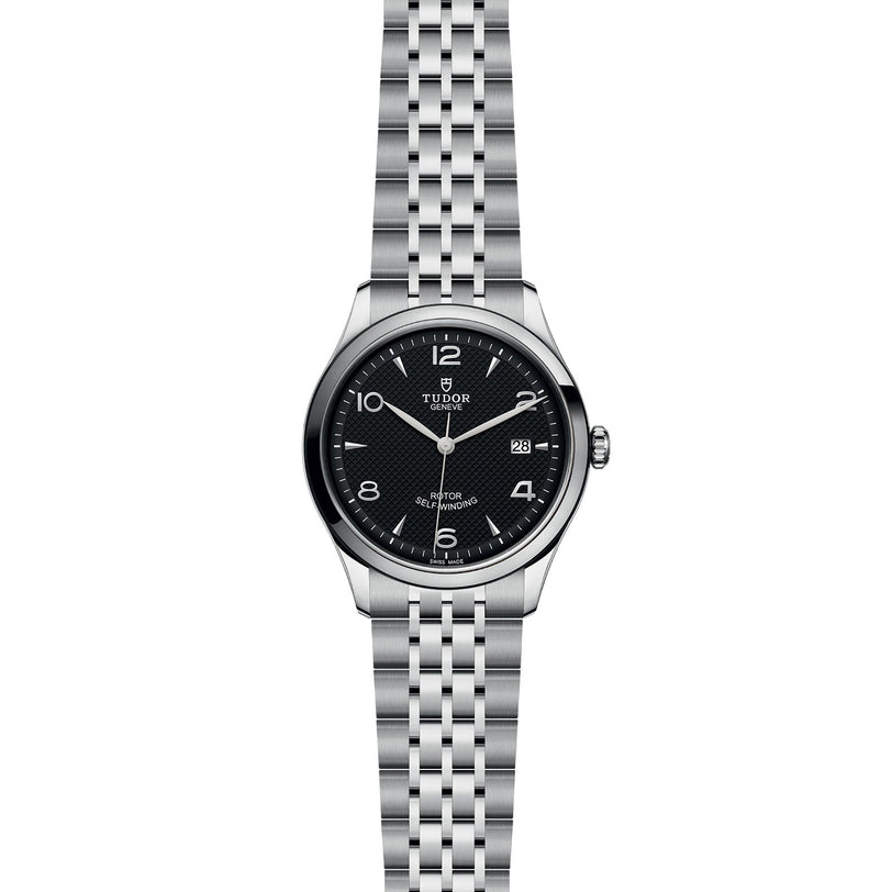 The TUDOR 1926 is a stainless steel wristwatch with a black dial, silver hour markers, date at 3 o’clock, and a metal bracelet—an elegant option for fans of mechanical watches.