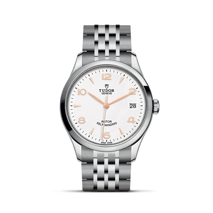 The TUDOR 1926 is a classic stainless steel watch featuring a white dial, gold hour markers, a date window at 3 o’clock, and a five-link metal bracelet—an elegant choice for mechanical watch enthusiasts.