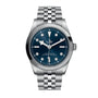 A TUDOR Black Bay One 36 wristwatch in stainless steel with a blue dial, silver hour markers, date display, and a metal link bracelet with the rapid adjustment system, presented on a white background.