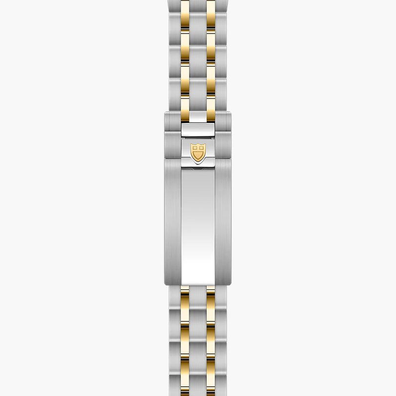Two-tone steel and gold watch bracelet with shield logo clasp, laid flat vertically.