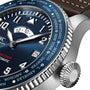 Close-up of the IWC Schaffhausen Pilots Watch Timezoner Edition Le Petit Prince with a blue dial, city names on the bezel, date window, leather strap with visible stitching, and a stainless steel case.