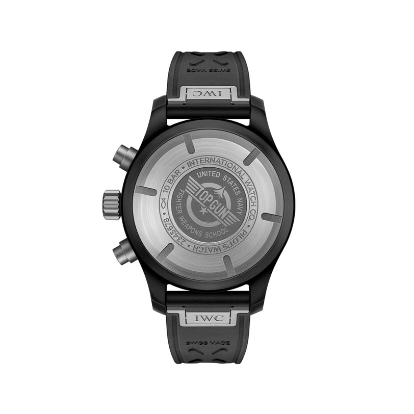 Black pilot chronograph watch with round case, gray rubber strap, and engraved caseback visible from behind.