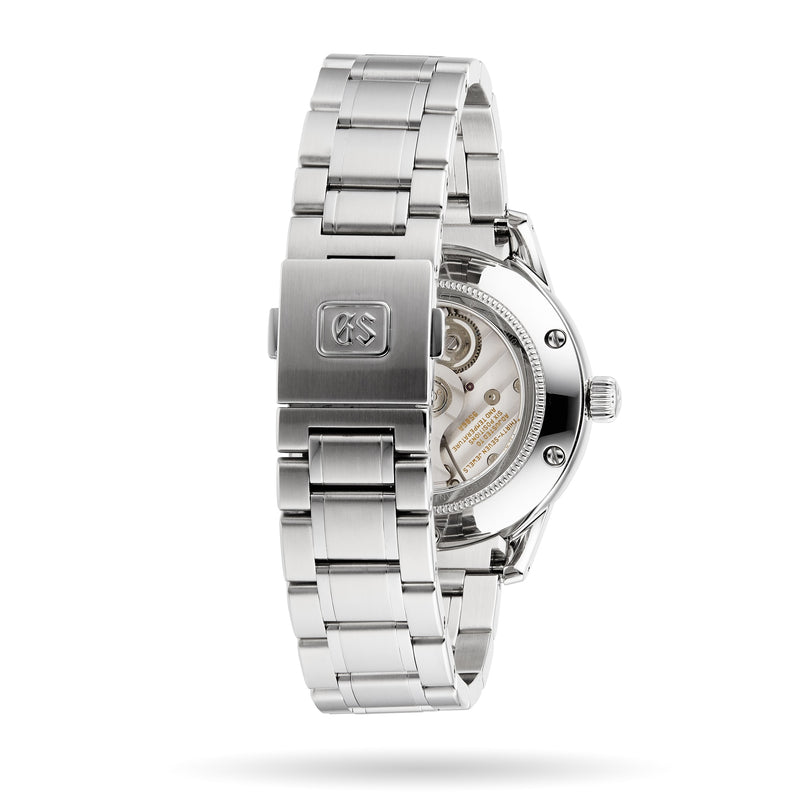 A Grand Seiko Hi-Beat GMT Elegance stainless steel watch with a clasp engraved logo, displaying its Calibre 9S86 movement through a transparent case back.