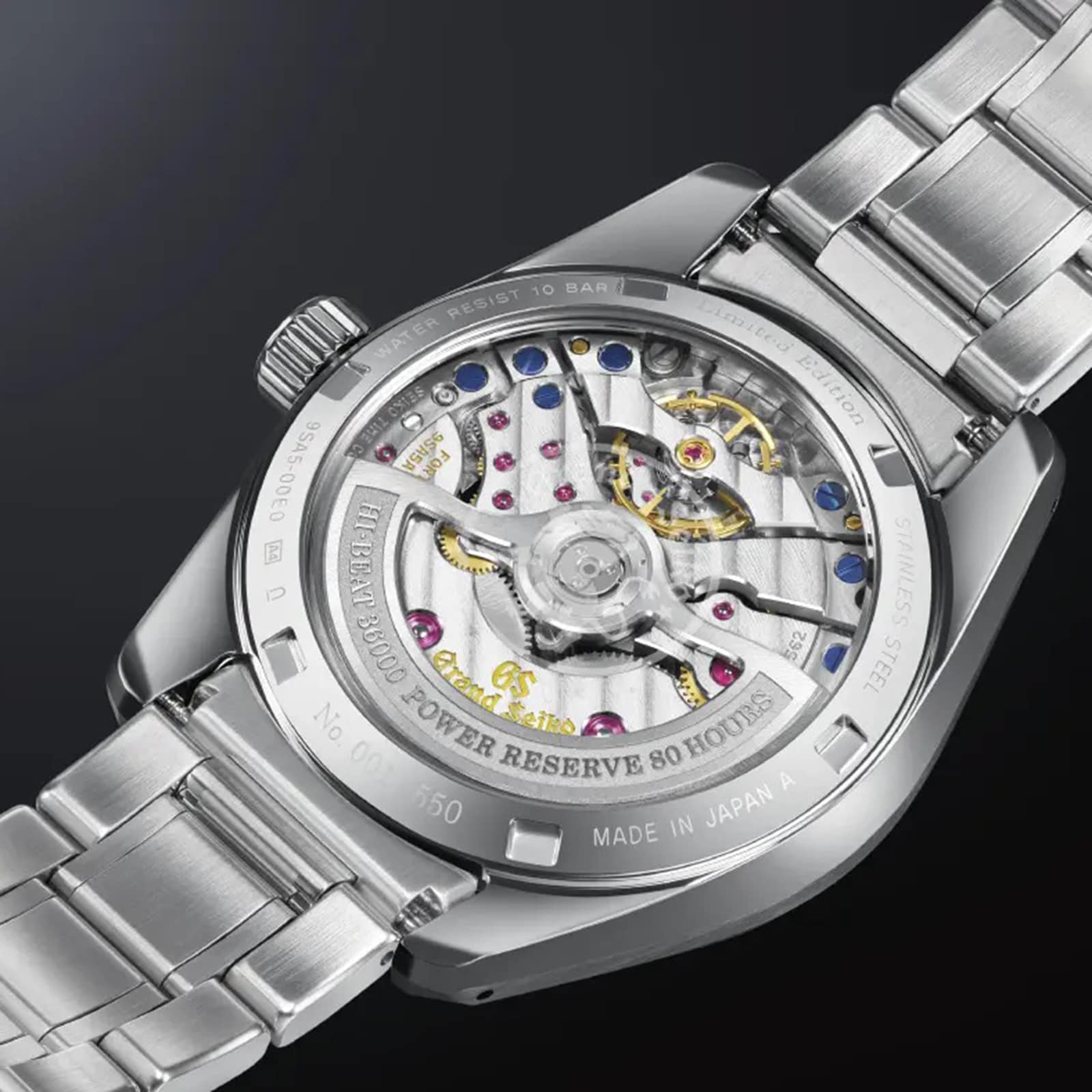 Close-up of the back of a Grand Seiko Hi-Beat Heritage stainless steel watch, revealing its precise mechanical movement and engraved caseback details.