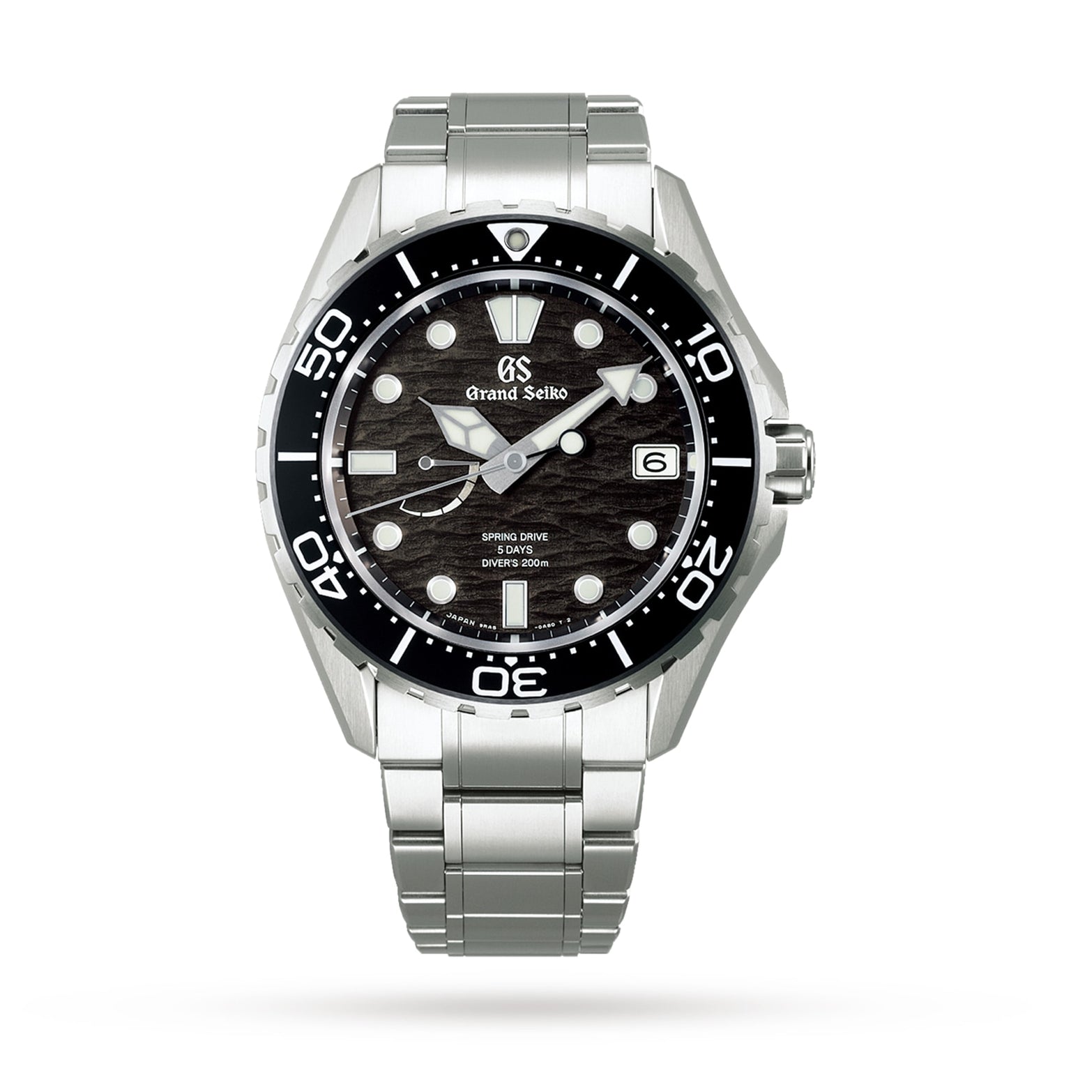 The Grand Seiko Spring Drive GMT Evolution 9 features a textured black dial inspired by Japanese nature, bold white hour markers, date at 3 o’clock, black unidirectional bezel, and stainless steel bracelet.
