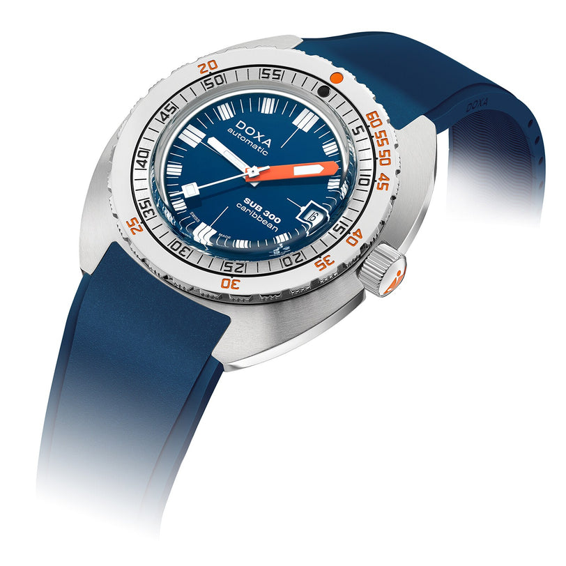 The DOXA Sub 300 Caribbean features a round stainless steel case, blue dial and strap, orange minute hand, and a unidirectional silver bezel with orange numerals.