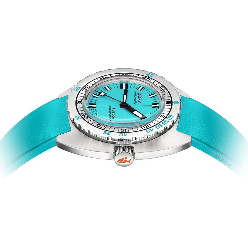 The DOXA Sub 300 Aquamarine divers watch features a turquoise dial with black indices, a matching strap, and a 316L stainless steel bezel, shown from the front at a slight angle.