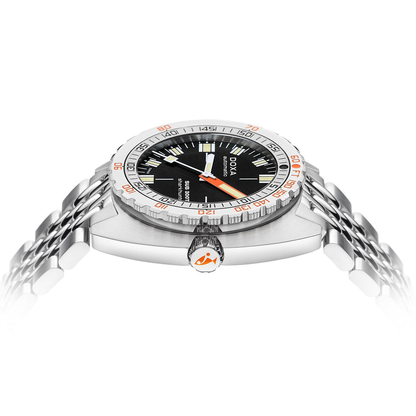 The DOXA Sub 300T Sharkhunter diver’s watch is shown from a side angle, featuring a stainless steel case, black dial, silver bezel with orange accents, and a steel bracelet.