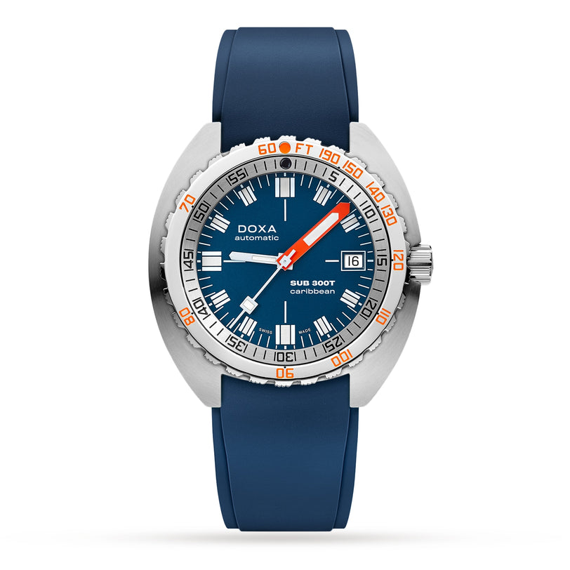 The DOXA Sub 300T Caribbean is a blue diver’s watch with a stainless steel case, unidirectional bezel, date display, blue rubber strap, and helium release valve for depths up to 120 bar.