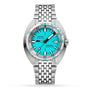 The DOXA Sub 300T Aquamarine is a stainless steel diver’s watch with an aquamarine dial, date at 3 o’clock, helium release valve, metal link bracelet, and a bezel showing depth in feet and meters.