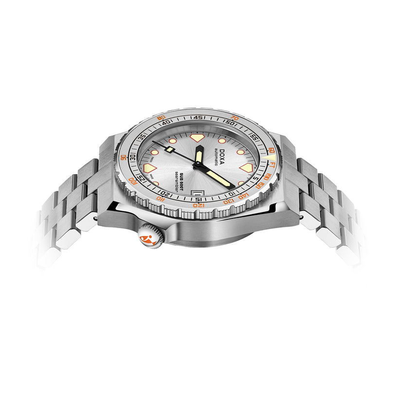 The DOXA Sub 600T Searambler is a stainless steel dive watch with a silver dial, orange accents, and a metal bracelet, shown at an angle on a white background.