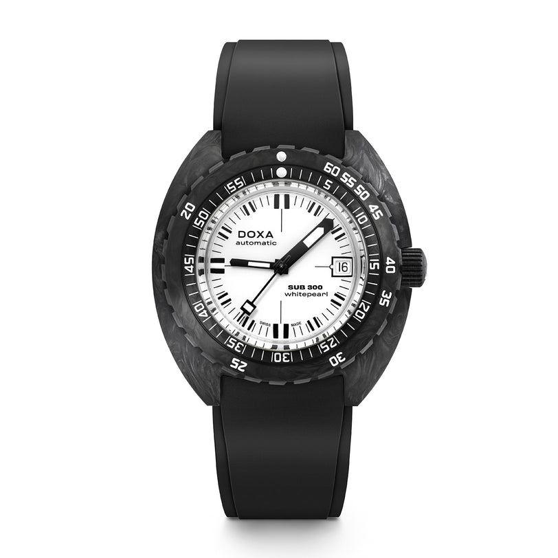 The DOXA Sub 300 Carbon Whitepearl is an automatic watch featuring a round face, black bezel, white dial, black rubber strap, and date display at 3 o’clock.