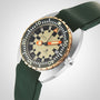 The DOXA Army Bronze by DOXA features a green strap, gold bezel, and a tan dial with black and orange accents.