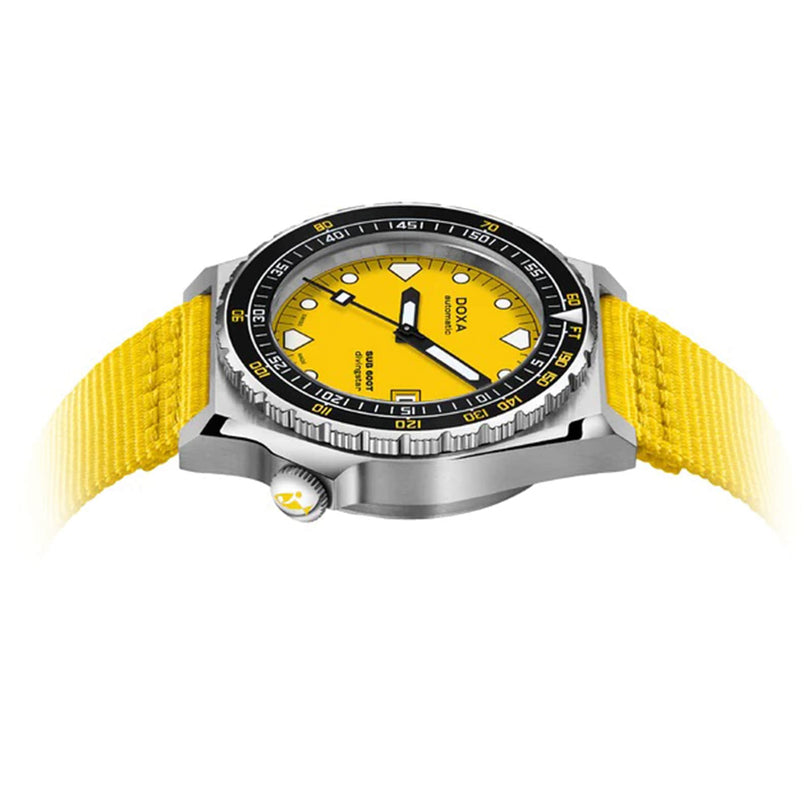 The DOXA Sub 600T Divingstar, featuring a yellow face, black rotating bezel, and yellow woven strap, is displayed at an angle on a white background.