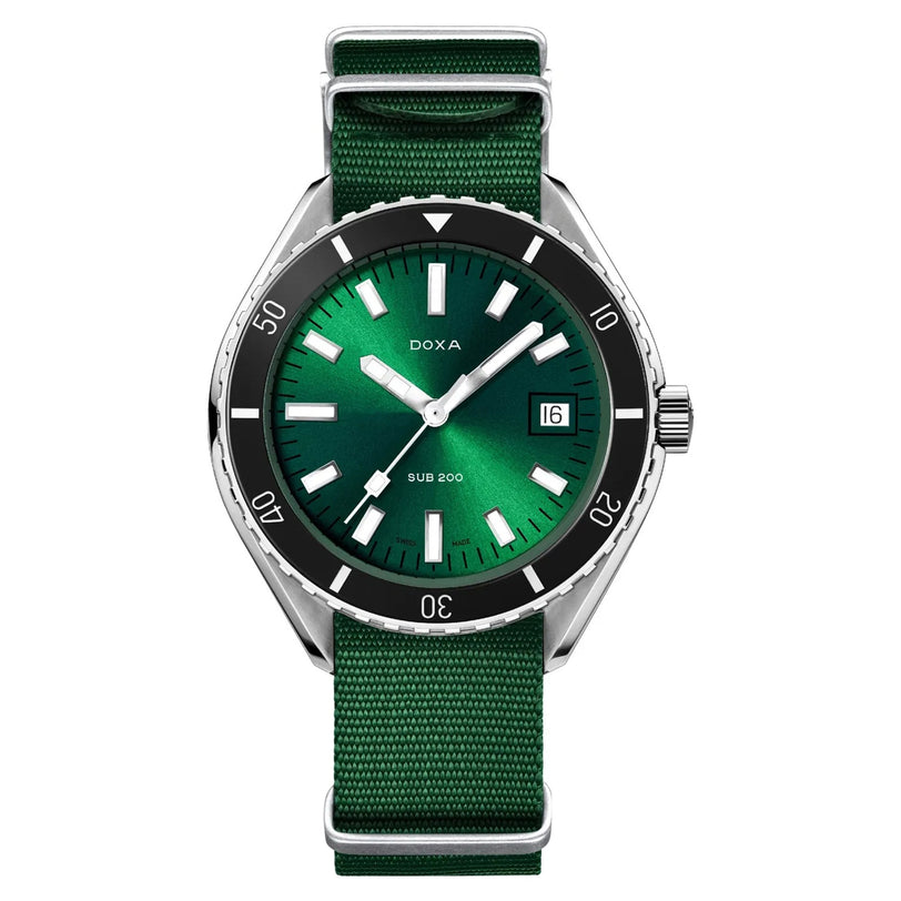 The DOXA Sub 200 Sea Emerald wristwatch, designed for deep-sea diving, features a green fabric strap, silver hour markers, black bezel, and date display at 3 o’clock—set against a white background.