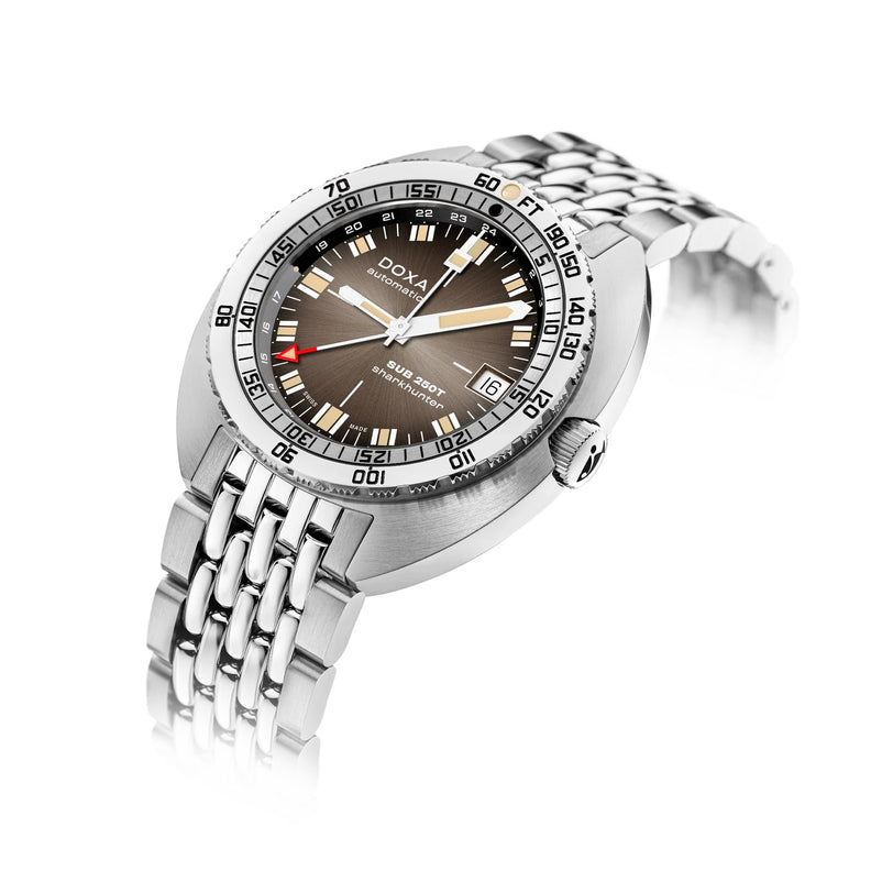 The DOXA SUB 250T GMT Sharkhunter Vintage is a stainless steel dive watch with a brown dial, date display, and metal link bracelet featuring Swiss automatic movement, shown at an angle on a white background.