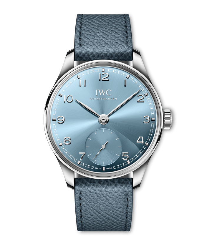 The IWC Schaffhausen Portugieser Automatic 40 features a silver case, sunburst light blue dial, silver hands and markers, small seconds above 6 o’clock, and a blue textured leather strap.