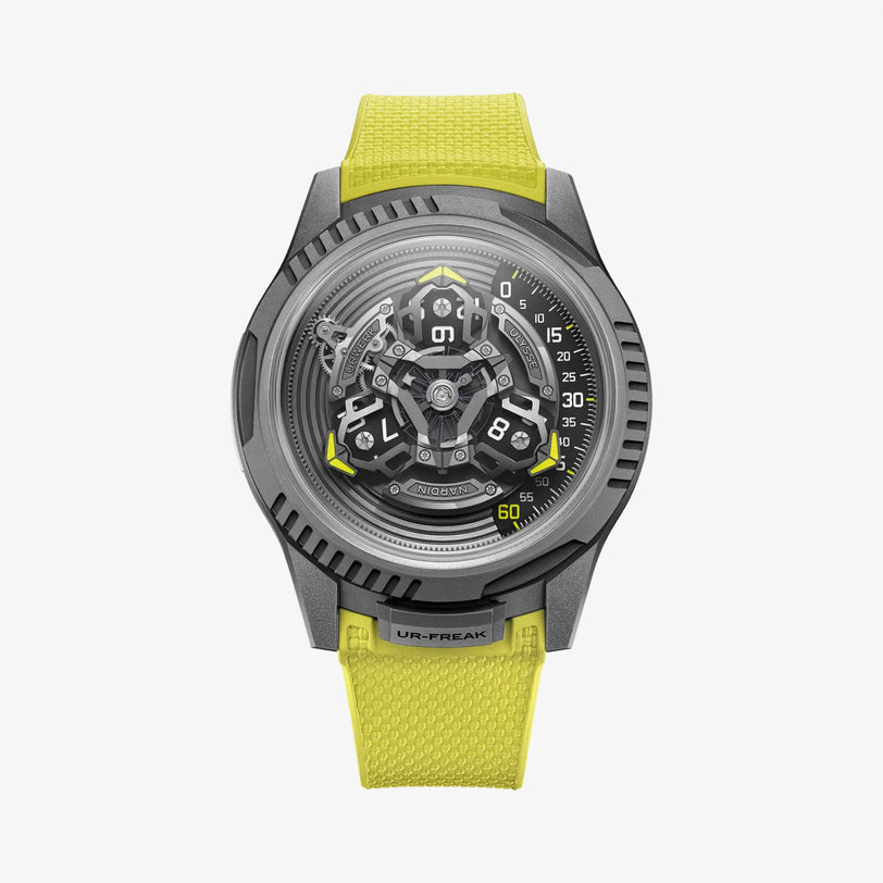 The Ulysse Nardin UR-FREAK is a futuristic wristwatch with a complex exposed mechanical dial, grey metallic case, and bright yellow textured strap, shown on a plain white background.