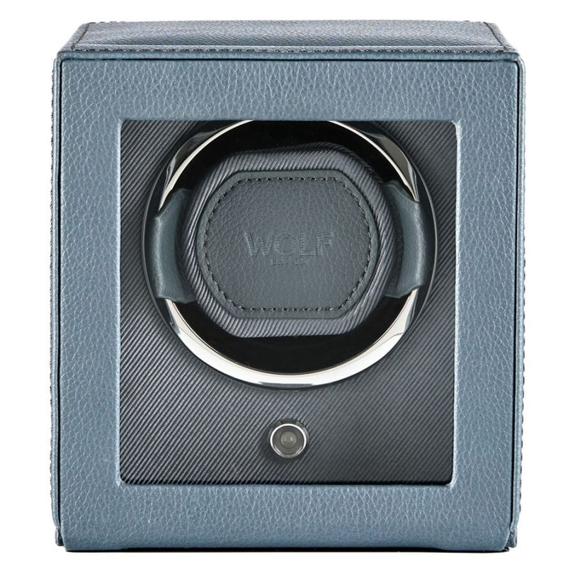 Gray leather watch winder with single circular cushioned watch holder and power button.