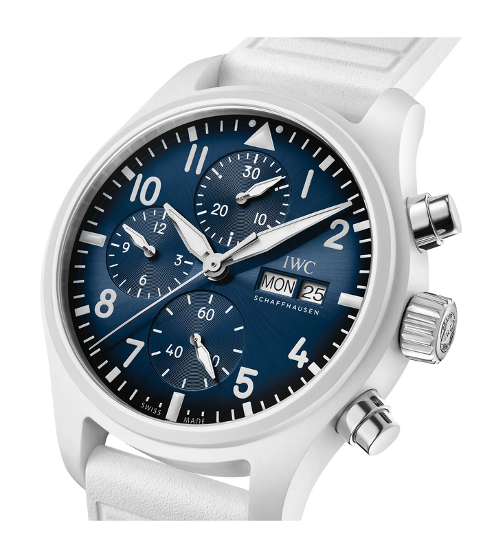 White chronograph watch with blue dial, Arabic numerals, three subdials, date window, and white leather strap.