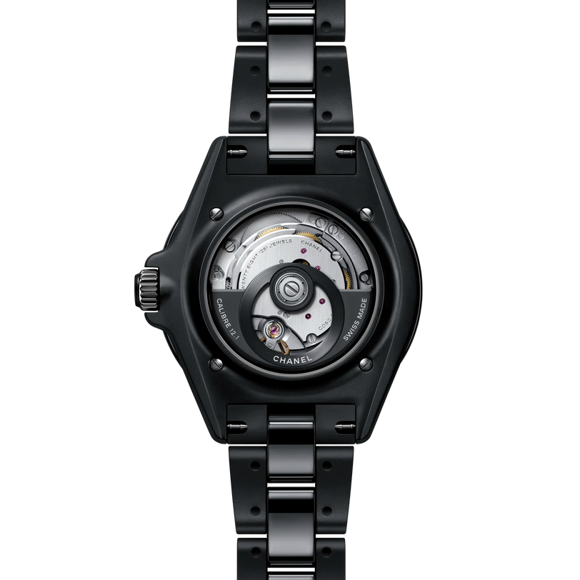 Black Chanel watch with mechanical components on a white background