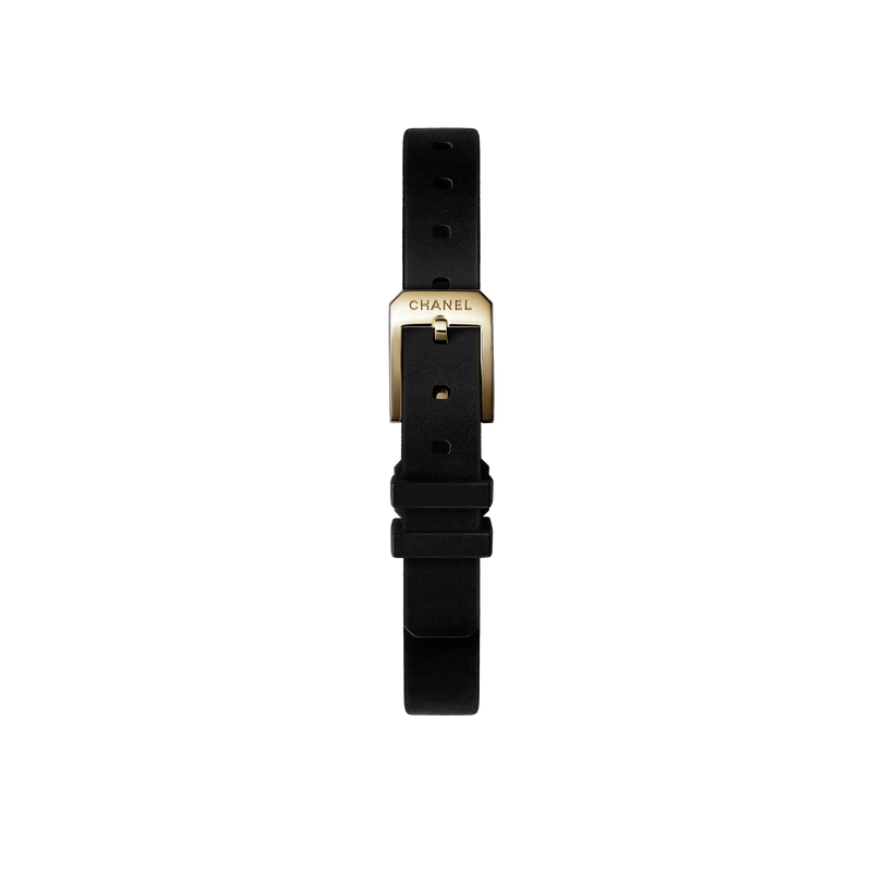 The Chanel Première Ribbon features a black strap and a yellow gold buckle engraved with "CHANEL," shown vertically against a plain white background.