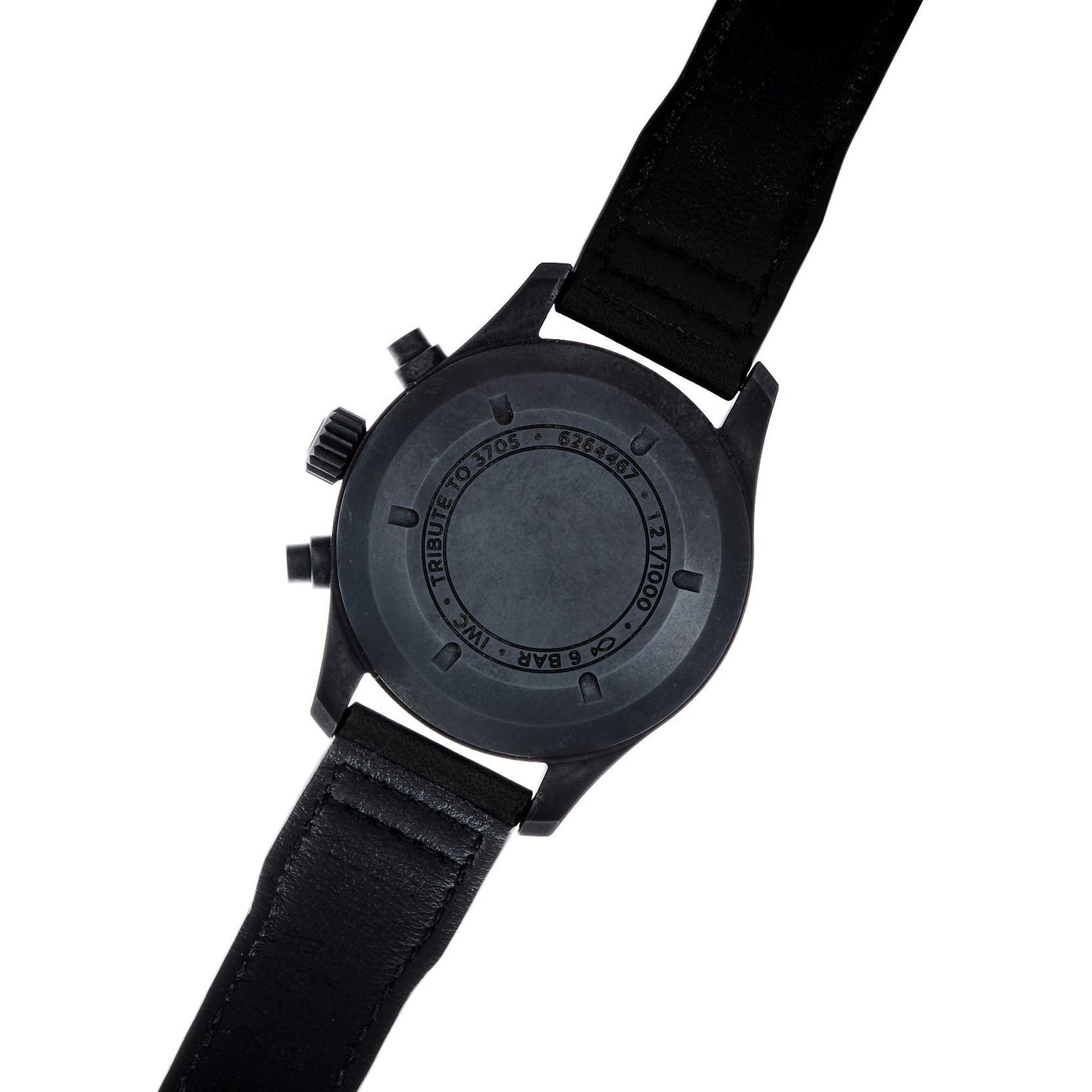 The IWC Schaffhausen Pilots Watch Chronograph Tribute To 3705 is shown from the back, featuring a black leather strap and engraved text on the case.