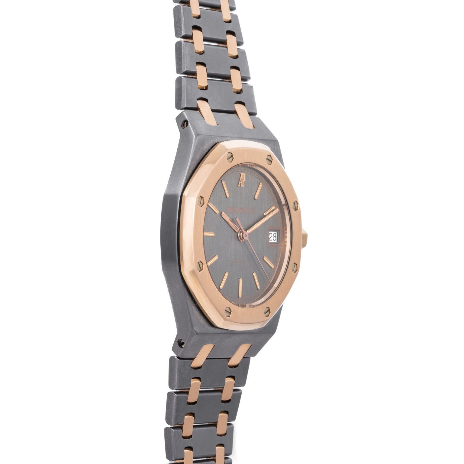 The Audemars Piguet Royal Oak Tantalum is a luxury two-tone wristwatch with a round face, gold bezel, metal link bracelet, and date display.