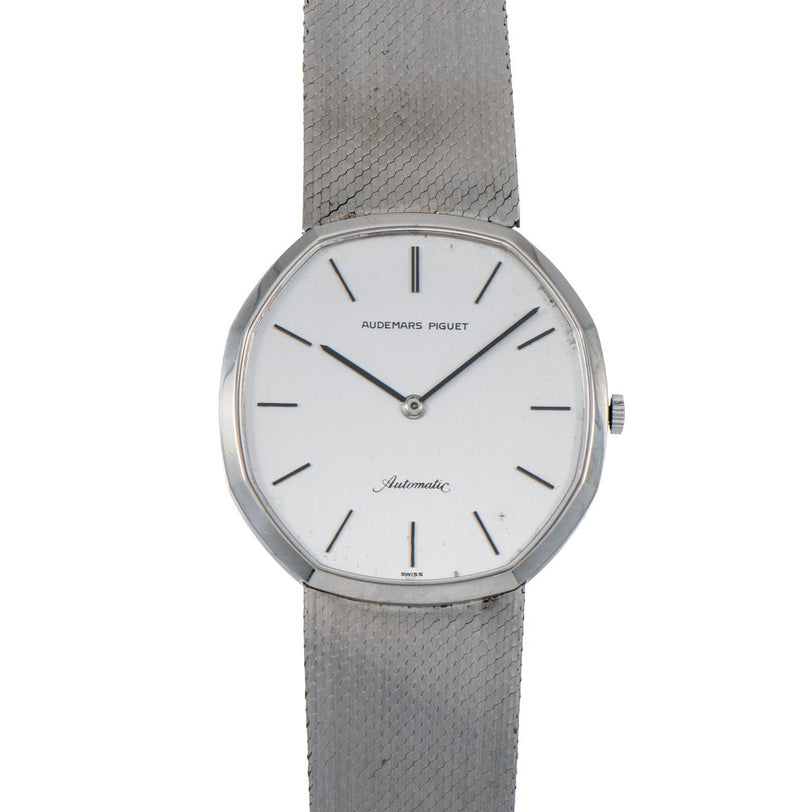 An Audemars Piguet Steel Dress Watch featuring a white dial, silver mesh band, and minimal hour markers.