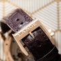 Close-up of a brown leather watch strap from Lange & Sohnes Richard Lange, featuring a gold buckle engraved with LANGE.