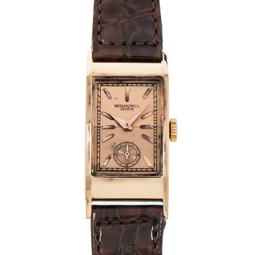 The Patek Philippe Tegolino Dress Watch features a rectangular gold case, brown leather strap, and a small seconds subdial.