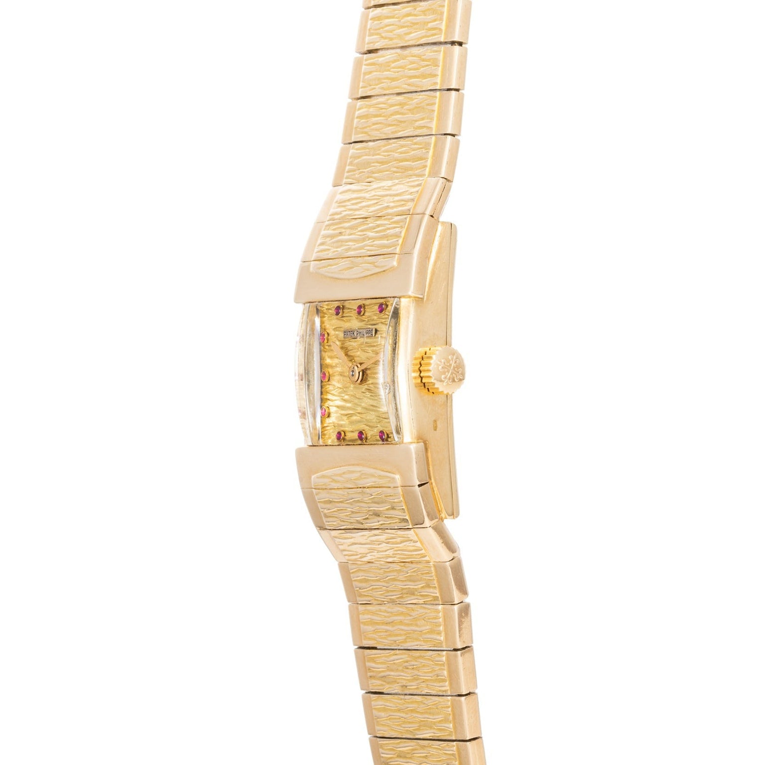 The Patek Philippe Yellow Gold Integrated Dress Watch features a textured band and rectangular face, displayed from a side angle.
