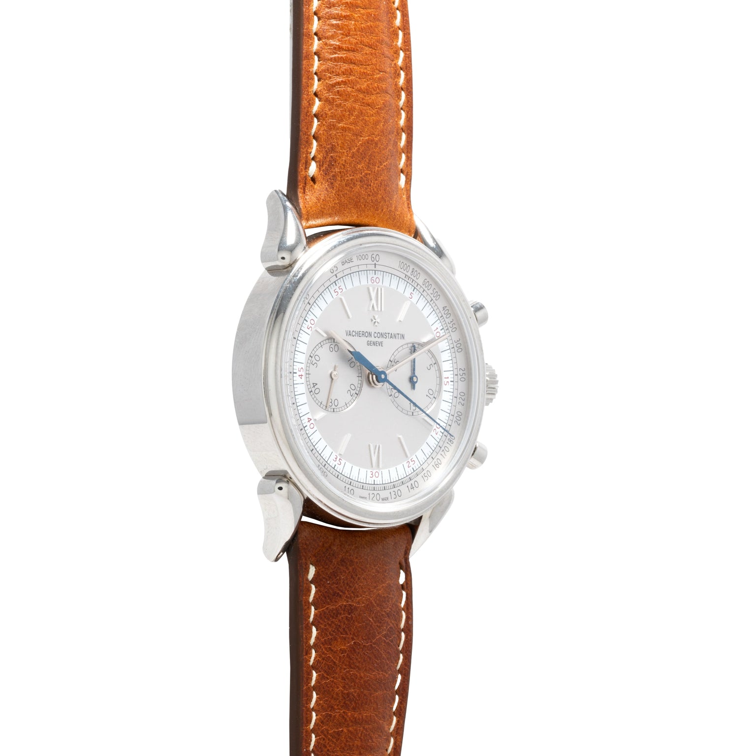 The Vacheron Constantin Historiques Cornes De Vache Chronograph is shown from the front, featuring a silver case, brown leather strap, and white dial.