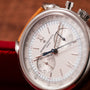 Close-up of the Vacheron Constantin Historiques Cornes De Vache Chronograph watch with a brown leather strap.