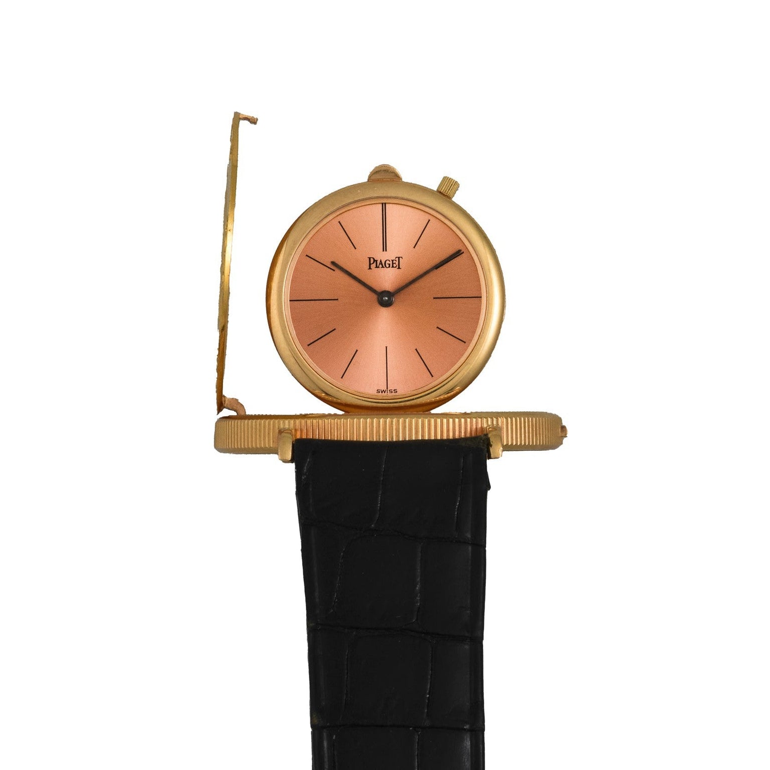 The Piaget 1877 Twenty Dollar Coin Watch features a peach dial, black leather strap, and a partially open hinged cover.