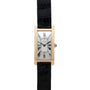 The Cartier Tank Cintrée Jumbo is a gold rectangular watch featuring Roman numerals and a black leather strap, showcased on a white background.