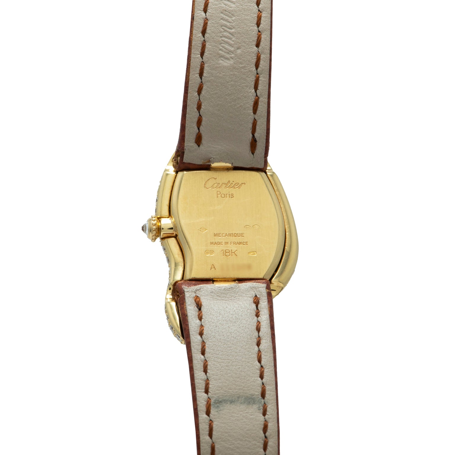 Cartier Crash Diamonds wristwatch back with tan leather strap and engraved text visible on the case.