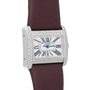 The Cartier Tank Divan is a luxury watch featuring a diamond bezel, Roman numeral markers, and a brown strap.