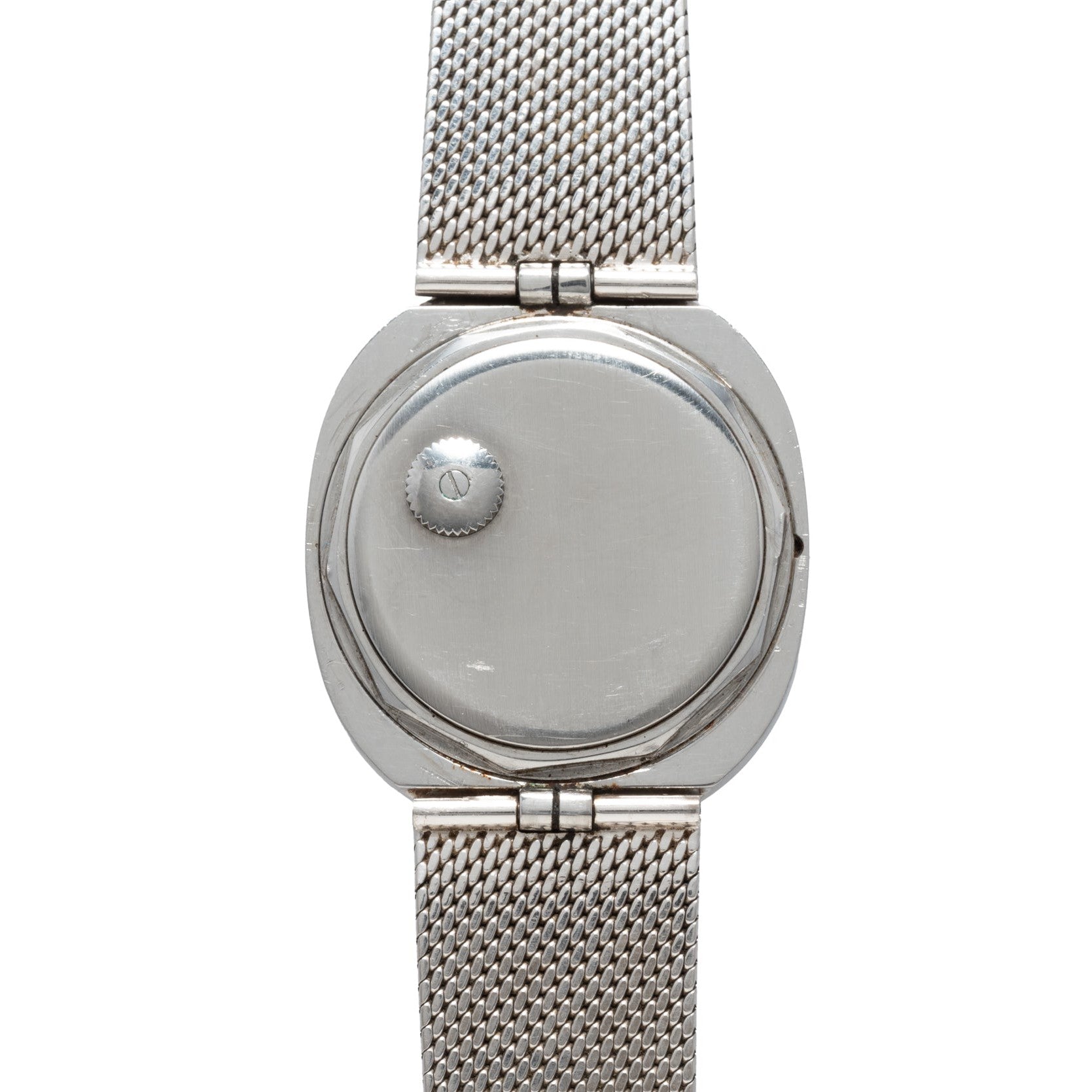 The Patek Philippe Dress Watch UFO features a silver mesh band and a smooth, blank face with no numbers or hands.
