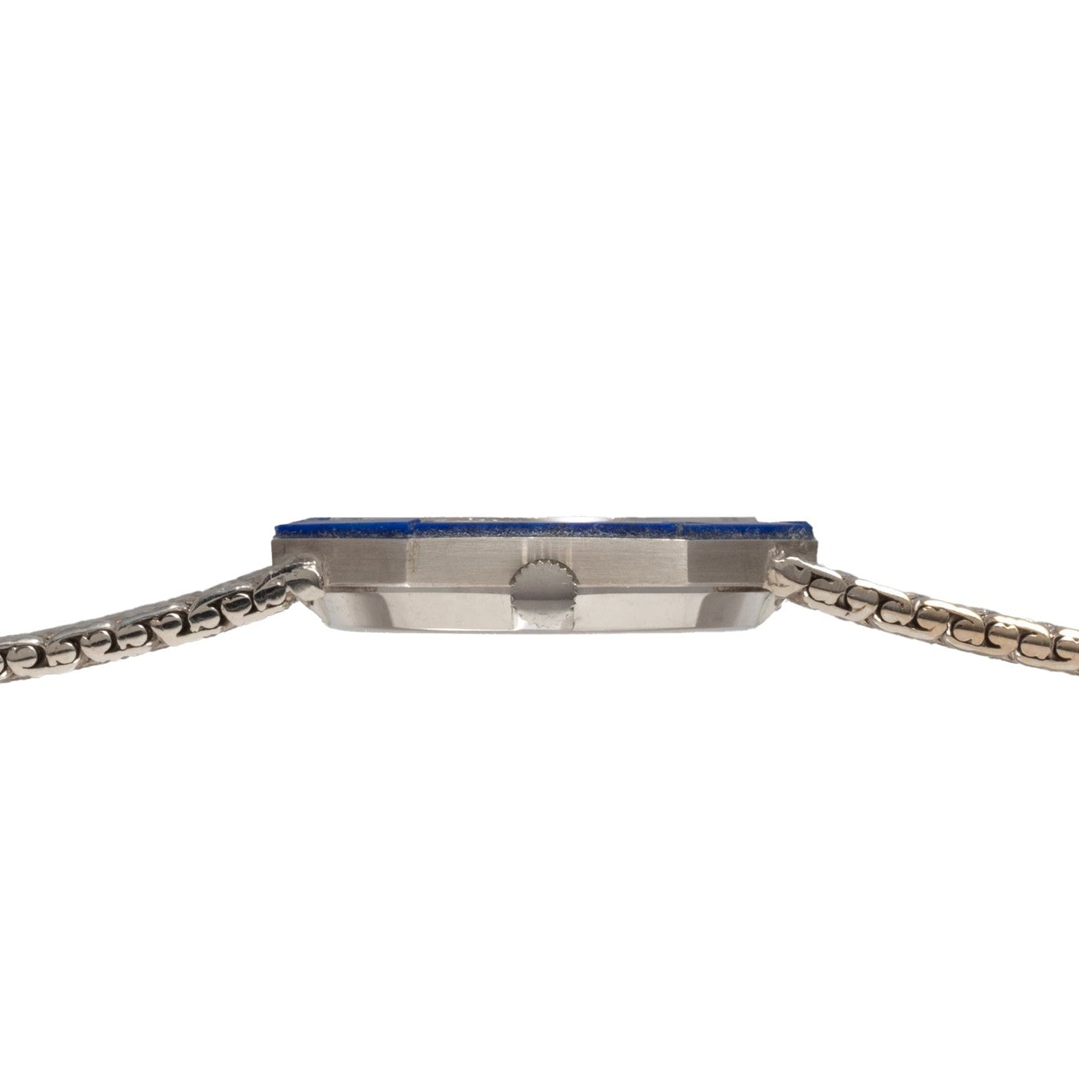 Side view of the Piaget Lapis Lazuli White Gold Dress Watch featuring a slim silver metal band and blue-edged face against a white background.