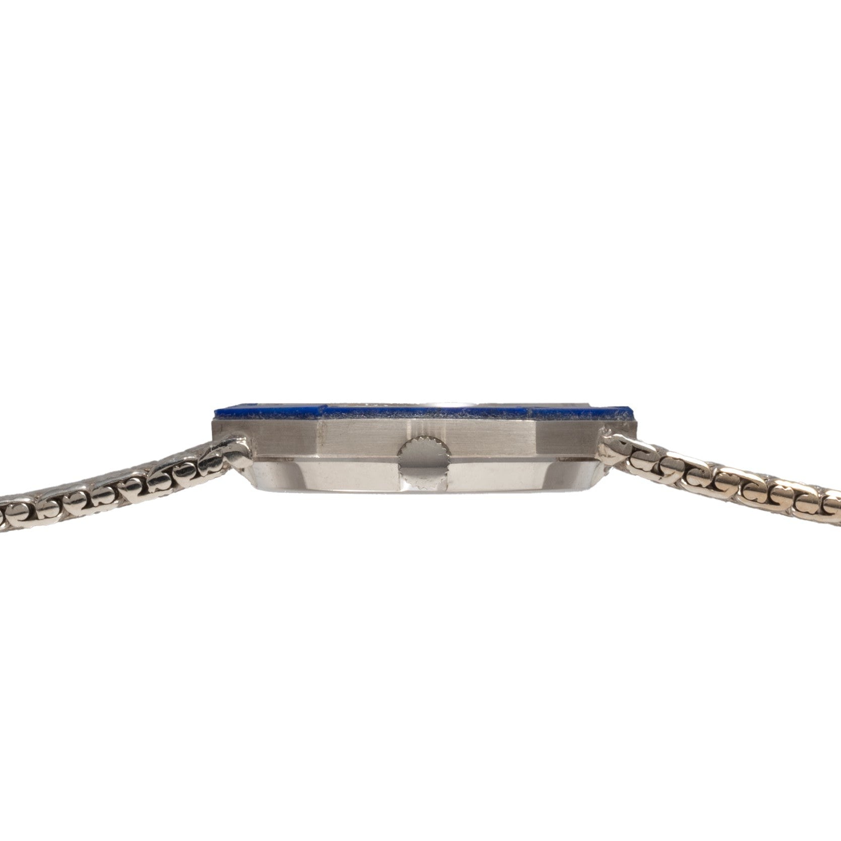 Side view of the Piaget Lapis Lazuli White Gold Dress Watch featuring a slim silver metal band and blue-edged face against a white background.