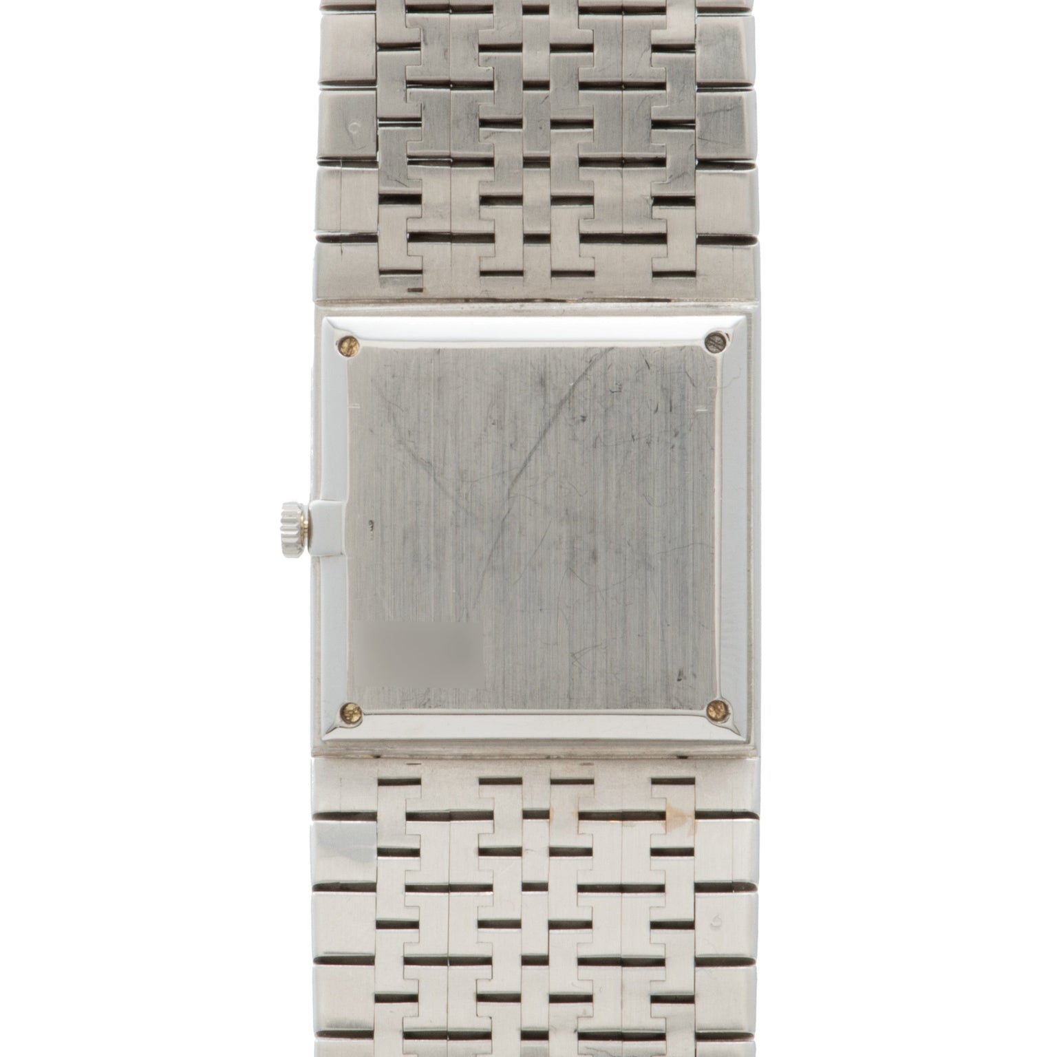A Piaget White Gold Onyx Dress Watch with a blank face and metal link band, viewed from above.