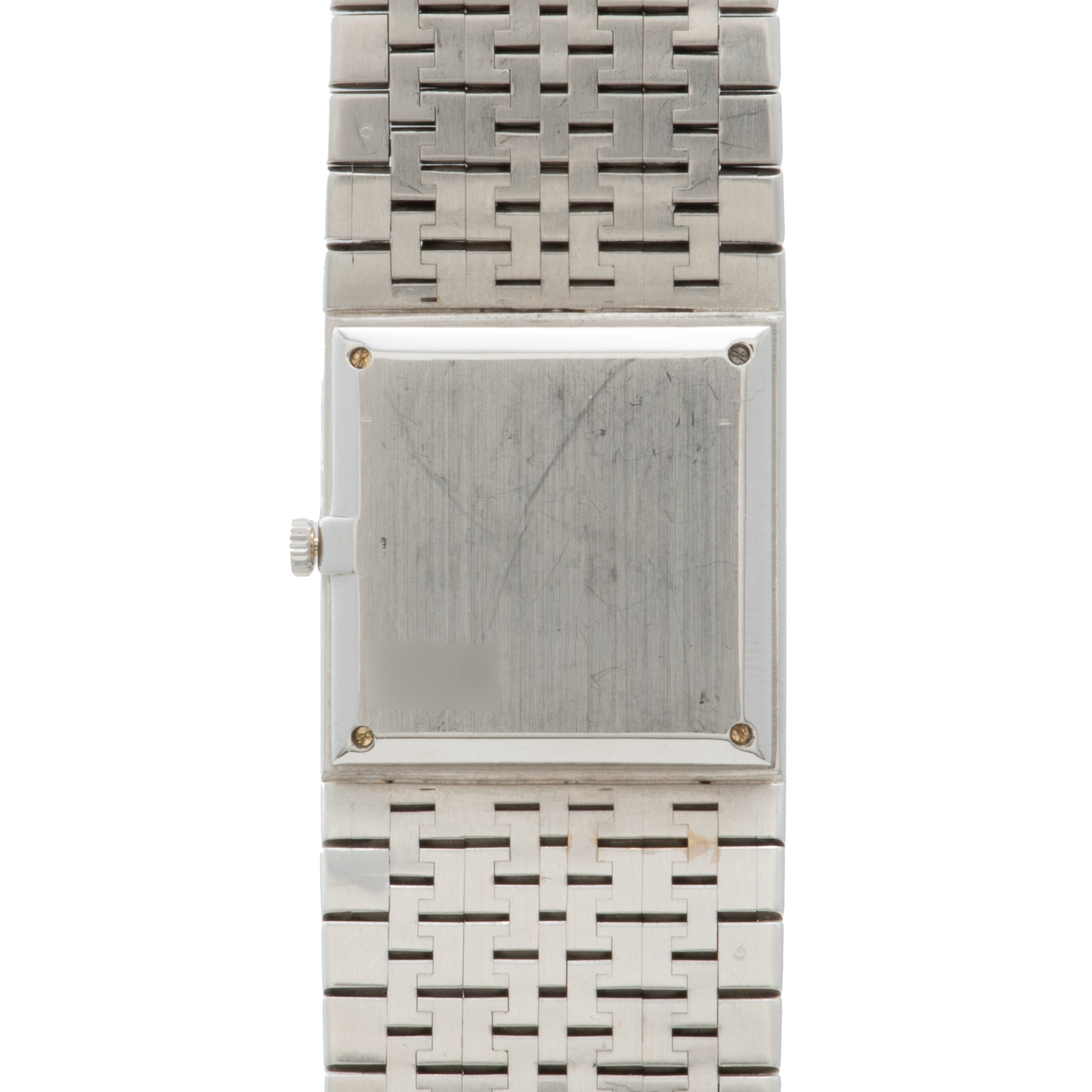 A Piaget White Gold Onyx Dress Watch with a blank face and metal link band, viewed from above.