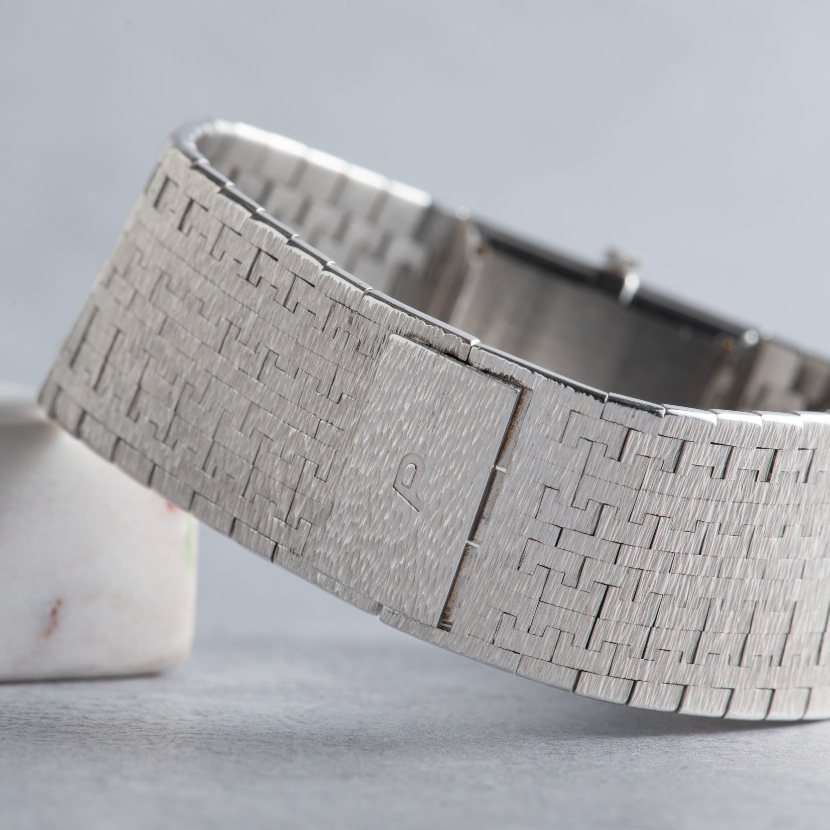 Close-up of the Piaget White Gold Onyx Dress Watch bracelet, featuring a textured, woven white gold band and a clasp.