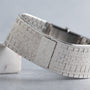 Close-up of the Piaget White Gold Onyx Dress Watch bracelet, featuring a textured, woven white gold band and a clasp.